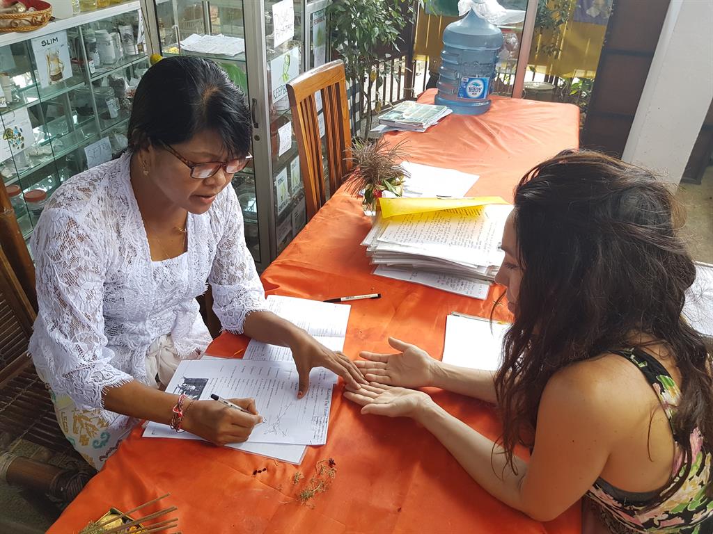 Talking hands: Lisa has her palm read by Jero Wayan Nuriasih