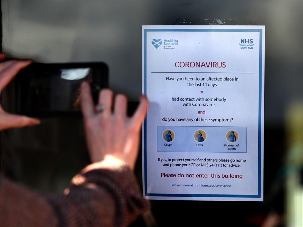 Northern menace: A general coronavirus warning sign at a sheltered housing complex in Kilmarnock, East Ayrshire