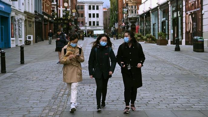 Millennials are being hit hard financially: Young people wearing face masks in Covent Garden, London PICTURE: EPA-EFE/NEIL HALL