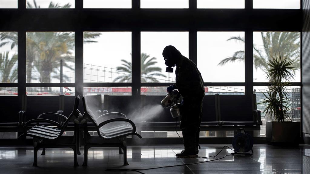A Spanish soldier sprays disinfectant in Menorca airport, Spain, April 15, 2020 PICTURE: DAVID ARQUIMBAU SINTES/EPA-EFE