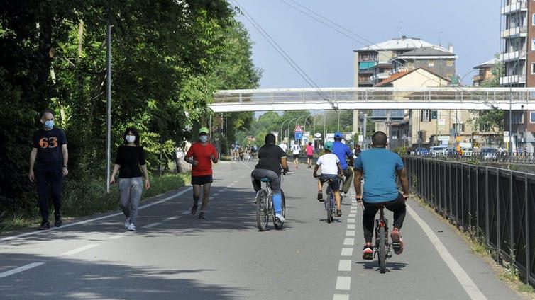 Sharing space: Runners, cyclists and walkers on the path between Corsico and Milan, Italy PICTURE: EPA-EFE/SERGIO PONTORIERI