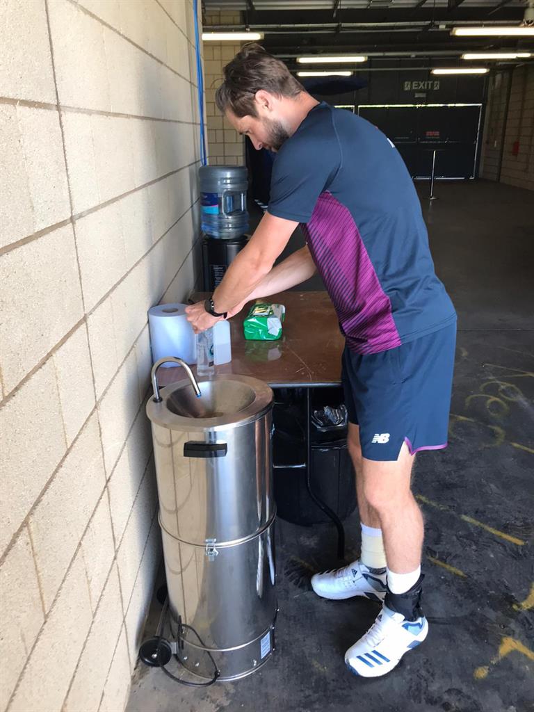Safety first: Woakes cleans his hands as he returned to training PICTURES: PA