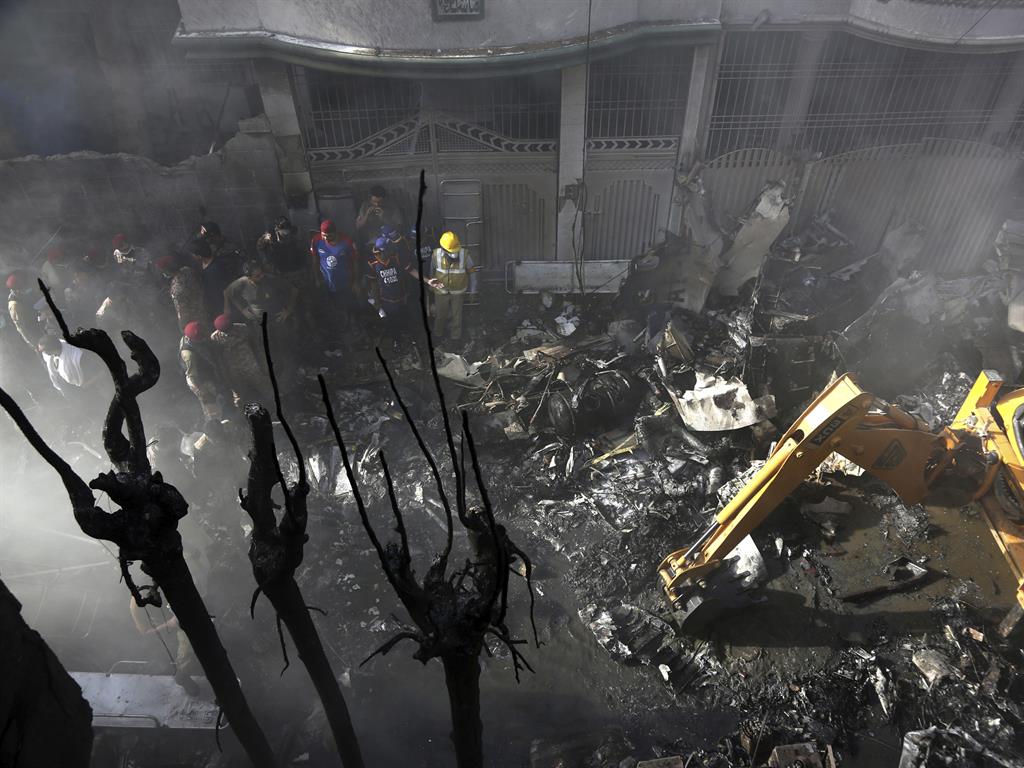 Crash site: The plane came down in a residential area of Karachi