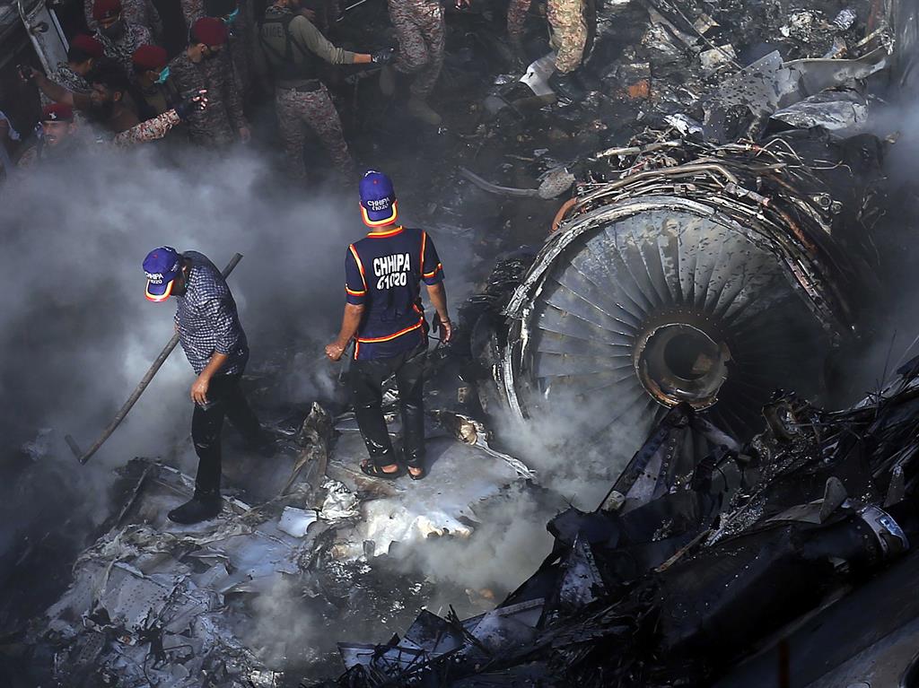 Wreckage: Rescue workers search for survivors