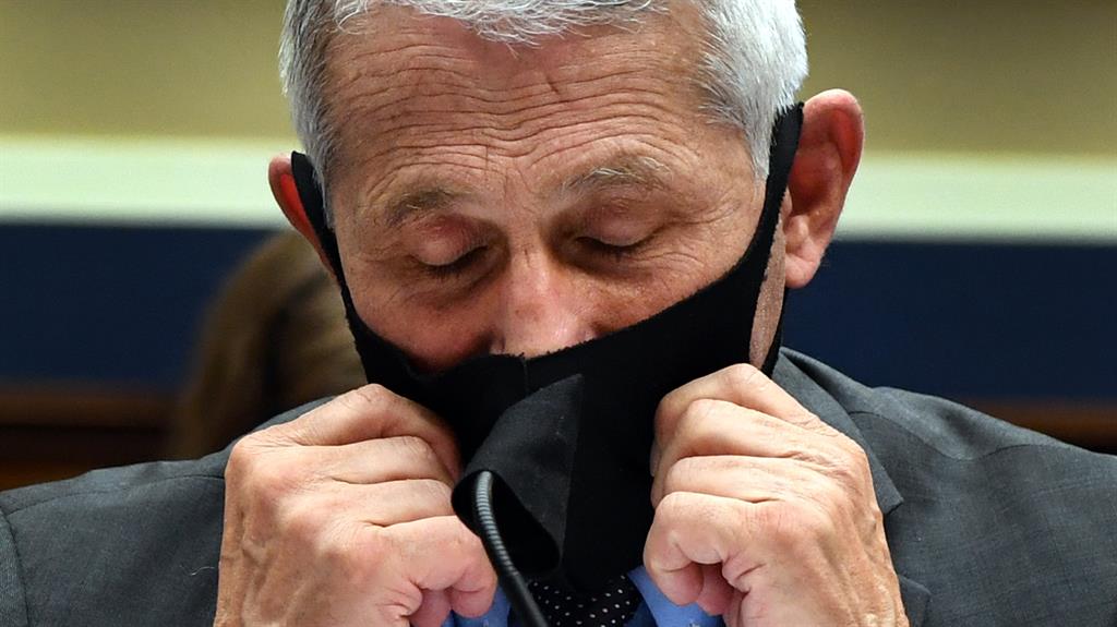 ‘Wear a mask’: Dr Anthony Fauci and, main picture, Mr Trump