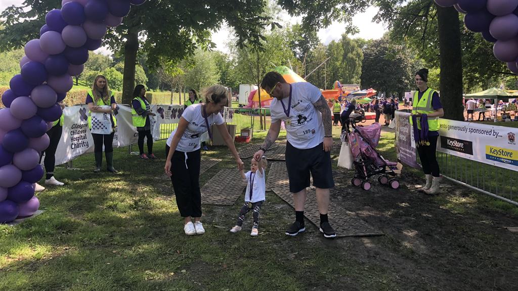 Finishing line: Clara completes the walk with her parents Sophie Cameron and Corey Healy PICTURES: SWNS