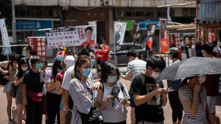 Effective action: Measures, including mask wearing, have worked to control the virus in Hong Kong, despite its density PICTURE: EPA-EFE