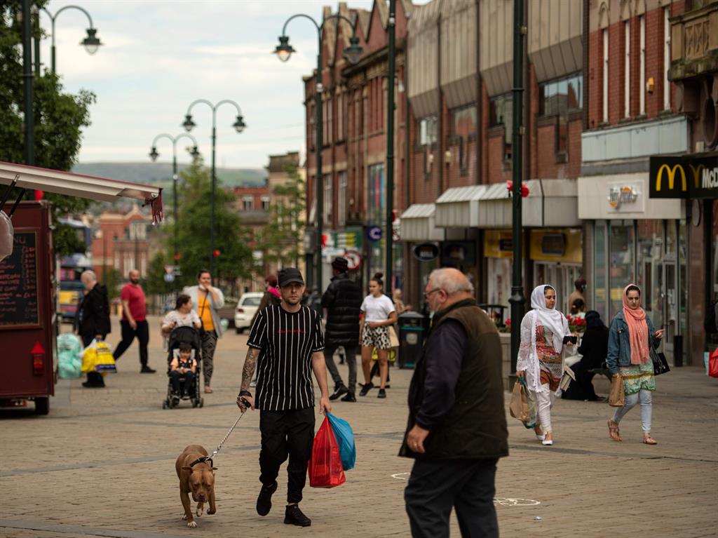 New rules: Shoppers in Oldham, Greater Manchester, where the lockdown has been partially reimposed PICTURES: GETTY