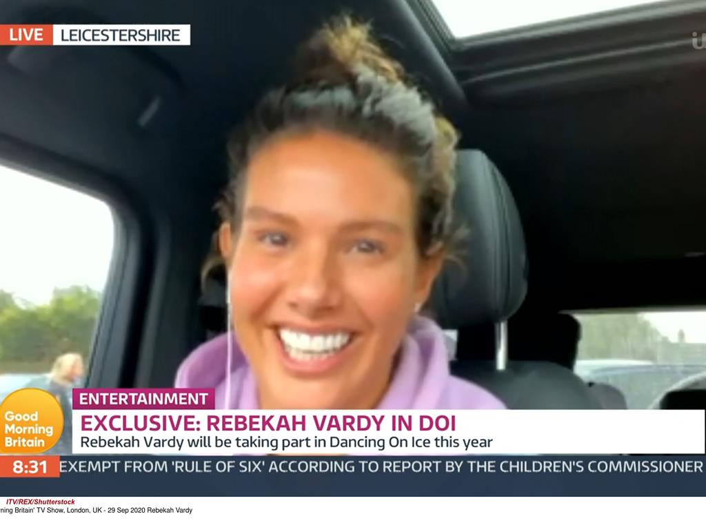 Mum on the run: Rebekah in her car this morning PICTURES: REX