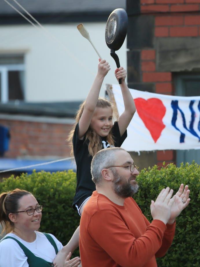 Pots and pans: Richard and Samantha Stretton with their daughter Macey-Mae, from Tyne and Wear, applaud and bang a frying pan during Clap for Carers PICTURE: PA