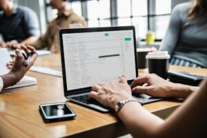 small business security - someone typing on a laptop in a cafe