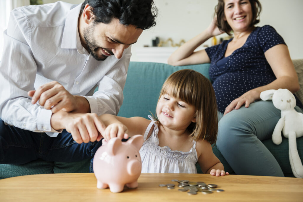family with piggy bank Providing Financial Security For Our Children