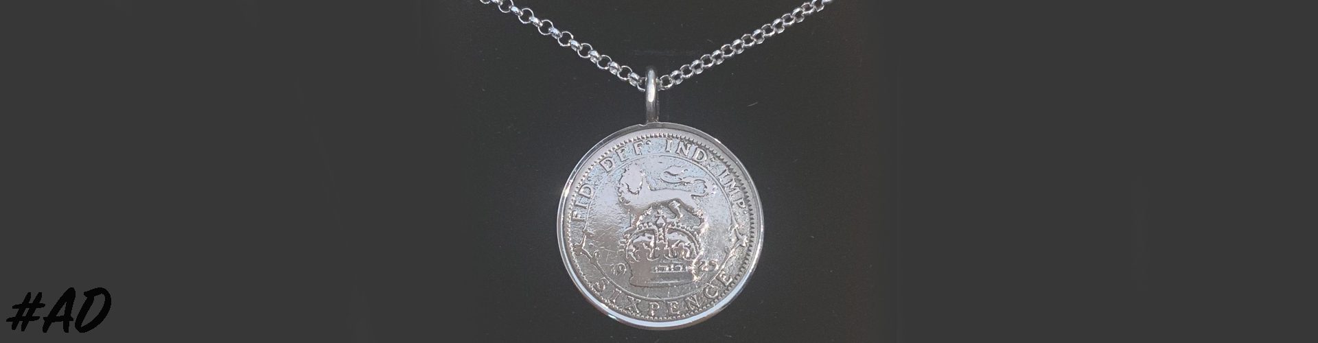 Close up of a 1925 Lucky Sixpence Pendant from Hersey & son