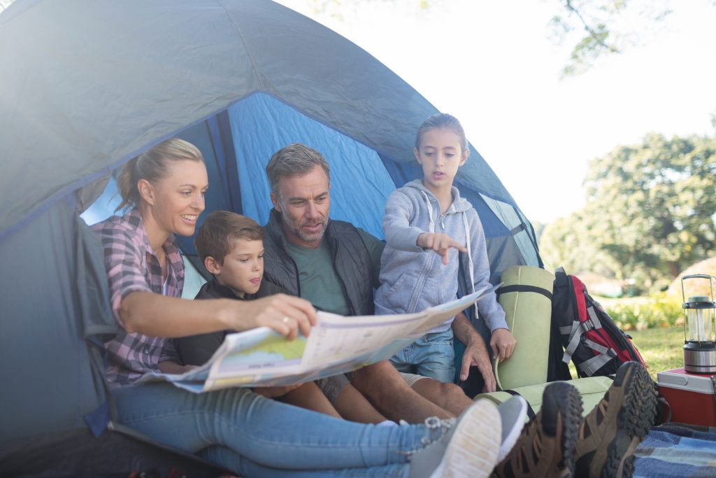 family inside a tent - dampen your camping experience