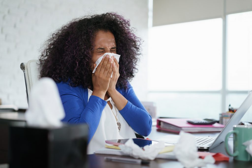 Black Woman Working from Home And Sneezing with hayfeer. don't ignore your allergy symptoms -