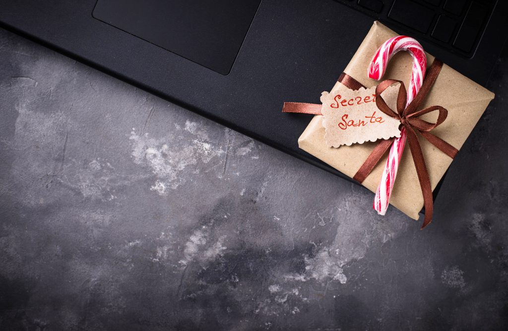 secret Santa gift sat on a laptop. From blog post titled Planning A Christmas Night Out When You're Self Employed