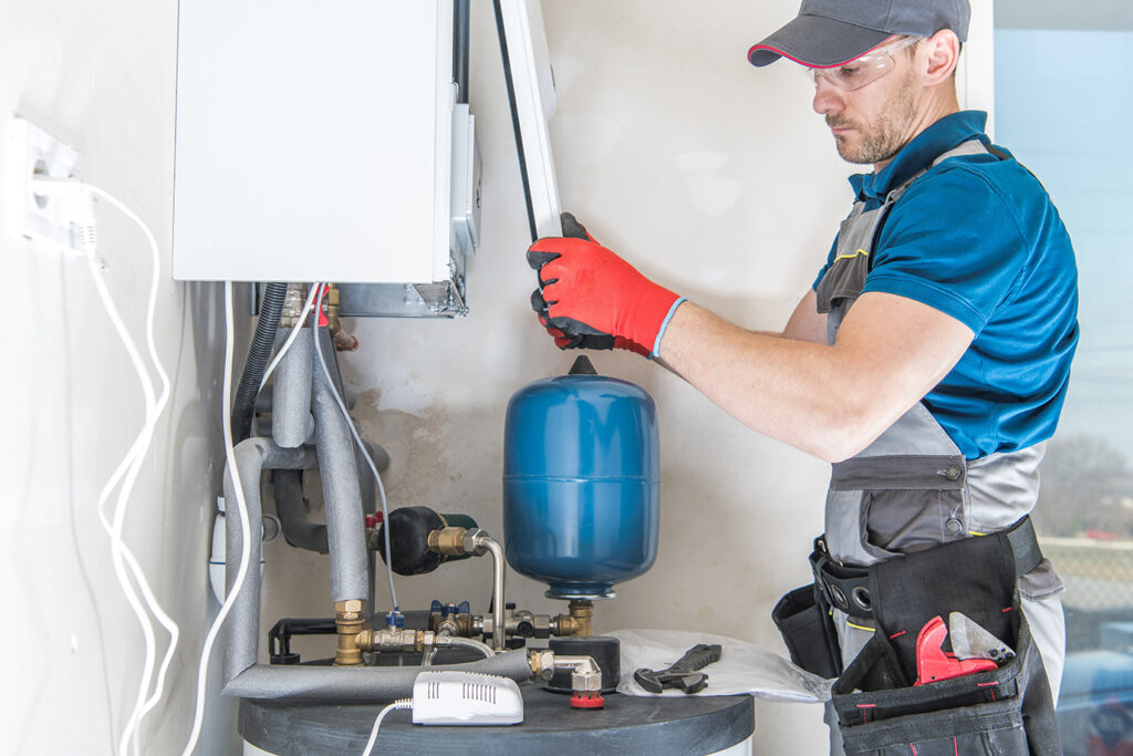 Engineer working on replacing the boiler at home