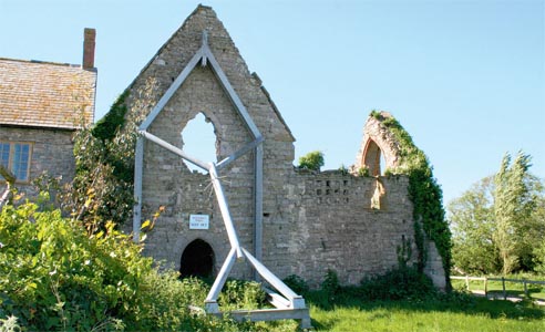 This building shows serious signs of subsidence and has been propped to prevent it from falling down altogether An old building that has been propped up with a wooden arm to prevent further subsidence