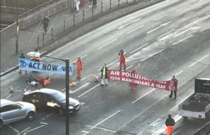 Extinction Rebellion protestors have blocked a road in Manchester city centre this morning
