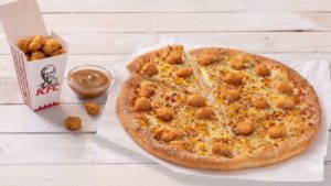 KFC and Pizza Hut team up to release a popcorn chicken and gravy pizza
