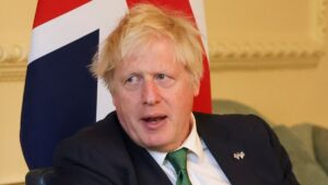 Boris Johnson was ‘not partying’ in photo of him drinking at ‘party’, Tory MP says