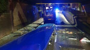 Double decker bus has entire roof sliced off after hitting bridge in Greater Manchester