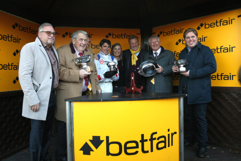 Harry Skelton and connections with the trophy after winning the Betfair Chase with Protektorat at Haydock