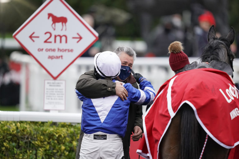 Bryony Frost gets a hug from Paul Nicholls after Frodon wins the King George