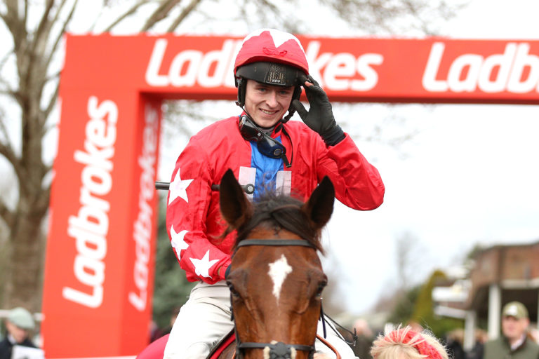 Jockey Niall Houlihan celebrates winning the Ladbrokes Desert Orchid Chase with horse Editeur Du Gite during day two of the Ladbrokes Christmas Festival at Kempton