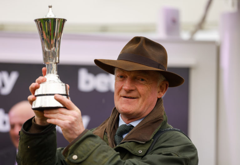 Trainer Willie Mullins receives his trophy after winning the Betway Queen Mother Champion Chase with Energumene