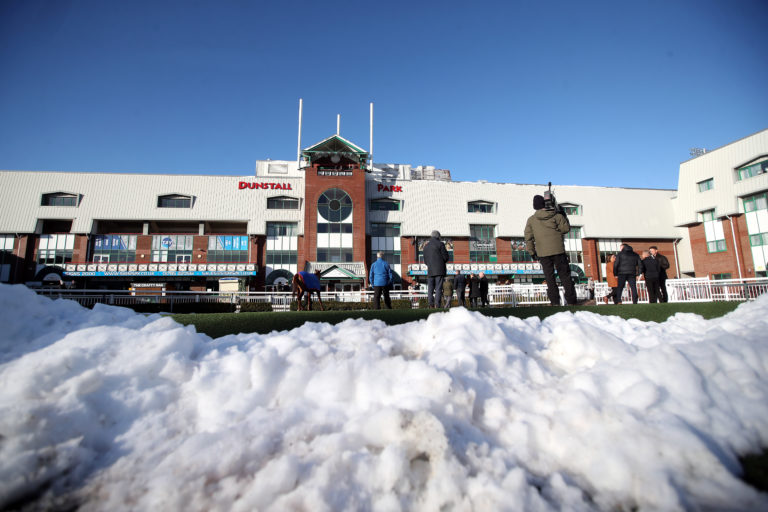Cleared snow piled up next to the parade ring at Wolverhampton