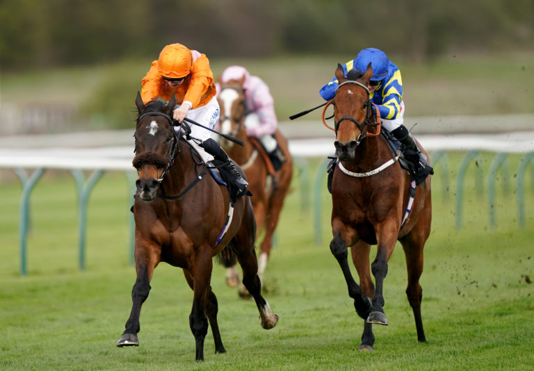 Rajinsky and Harry Davies (orange) coming home to win the Barry Hills Further Flight Stakes at Nottingham racecourse