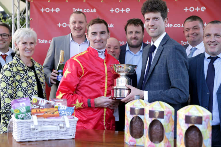 Tudhope and trainer Adam Nicol hold the Queen's Cup after their Musselburgh success