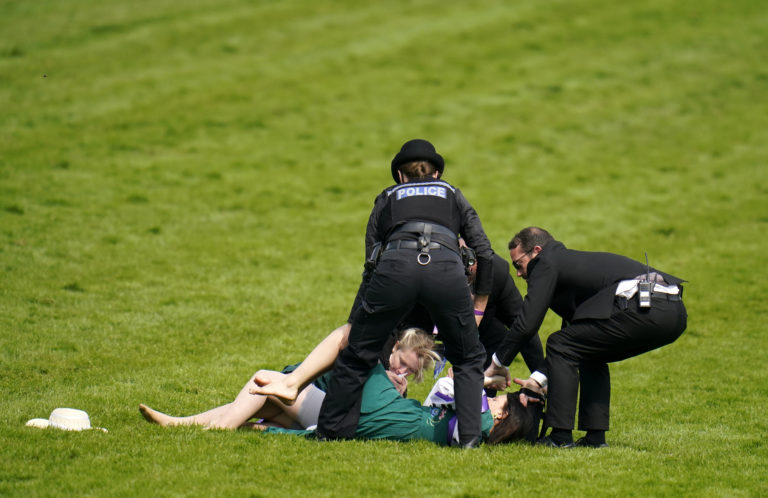Protesters being removed from the track at the Derby meeting last year