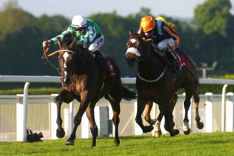 Roberto Escobarr (left) ridden by jockey Richard Kingscote (left) on their way to winning the Racehorse Lotto Henry Ii Stakes at Sandown