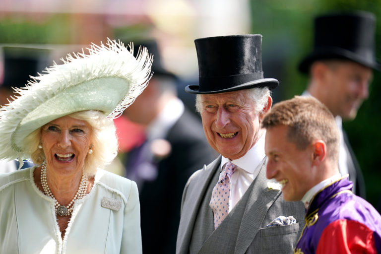 King Charles III and Queen Camilla greet their winning jockey