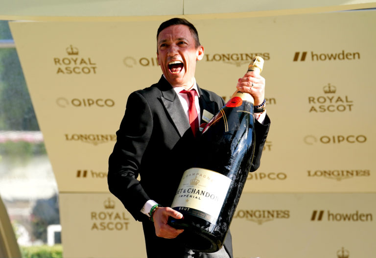 Frankie Dettori celebrates with an oversized bottle of Moet & Chandon after completing his final Royal Ascot before retirement