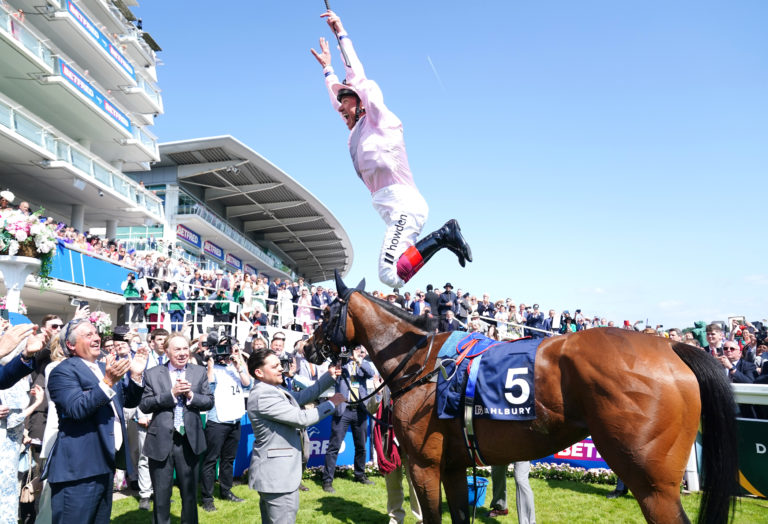 Frankie Dettori celebrates victory at Epsom with Emily Upjohn