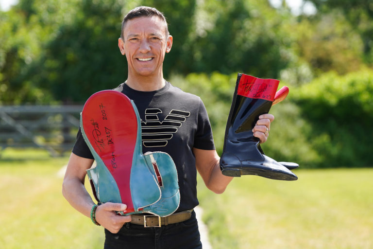 Frankie Dettori with a saddle and boots that will be auctioned