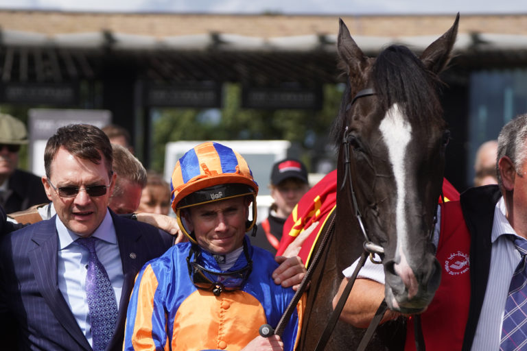 Auguste Rodin with trainer Aidan O'Brien and jockey Ryan Moore after winning the Dubai Duty Free Irish Derby