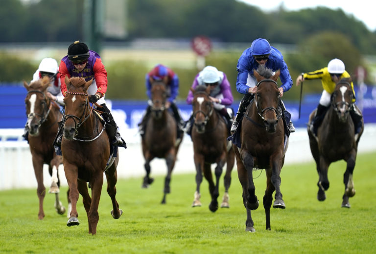 Chesspiece (blue) finishing second to Desert Hero at Goodwood