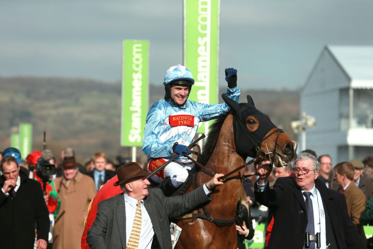 Tom Scudamore celebrates on Western Warhorse after victory in the Arkle
