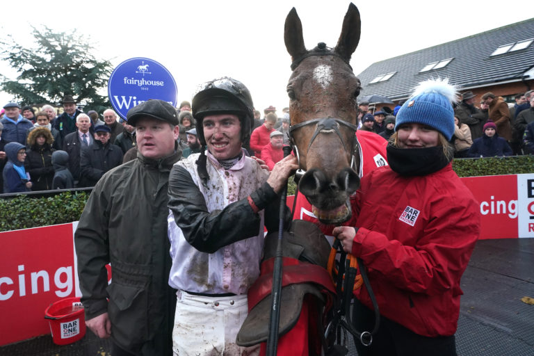 Jockey Jack Kennedy (centre) and trainer Gordon Elliott (left) celebrate with Teahupoo after winning the Hatton's Grace