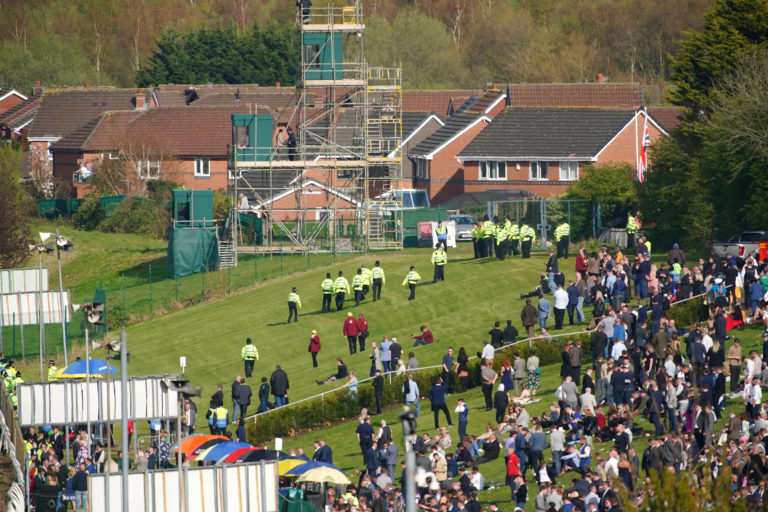 Police officers respond to Animal Rising activists attempting to invade the course ahead of the Randox Grand National