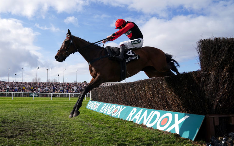 Sam Brown on his way to winning the Betway Handicap Chase during Grand National Day in 2022
