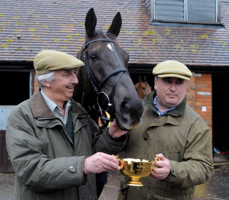 Paul Nicholls (right) holds the Cheltenham Gold Cup with part owner Paul Barber and Denman