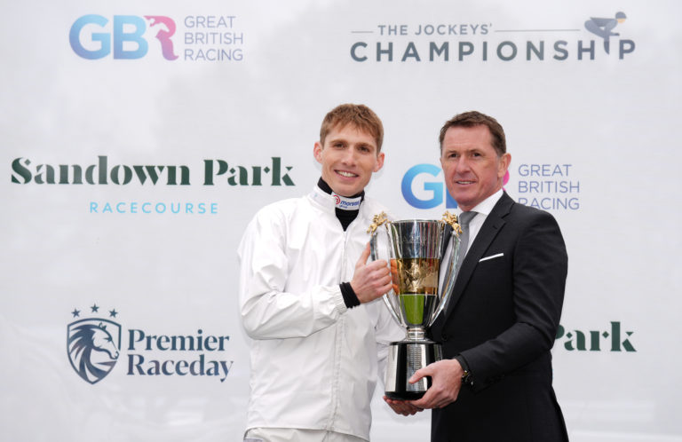 Harry Cobden (left) gets his trophy off AP McCoy 