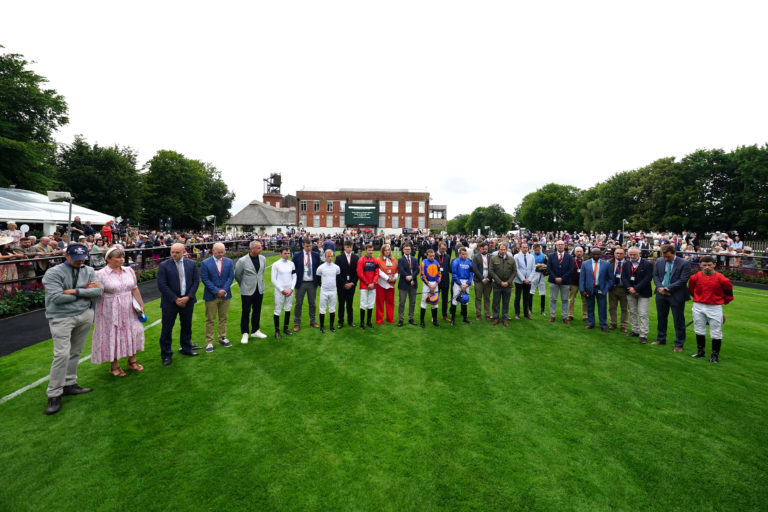 A general view of a minute silence being observed for Carol, Louise and Hannah Hunt at Newmarket 