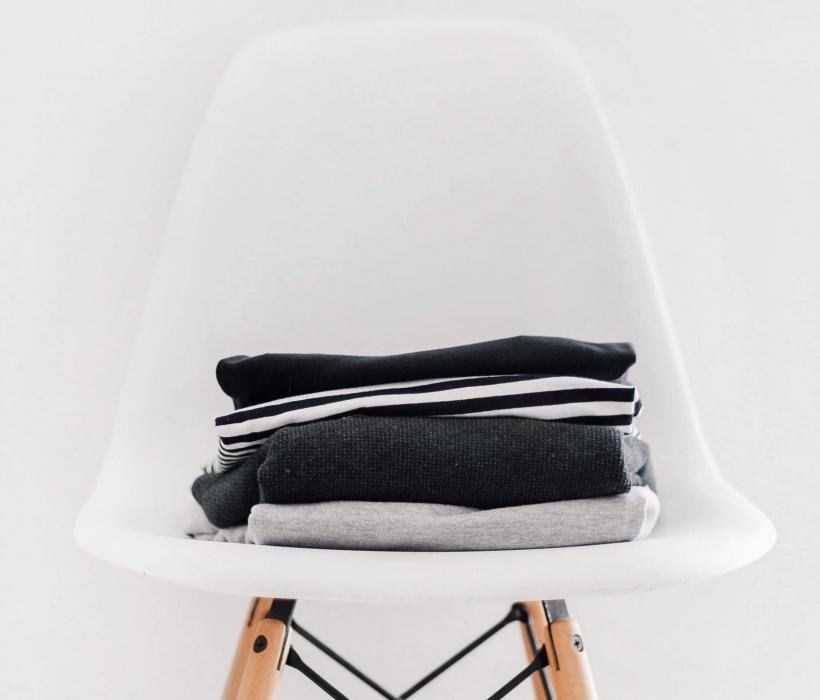 Pile of basic t-shirts and sweaters.