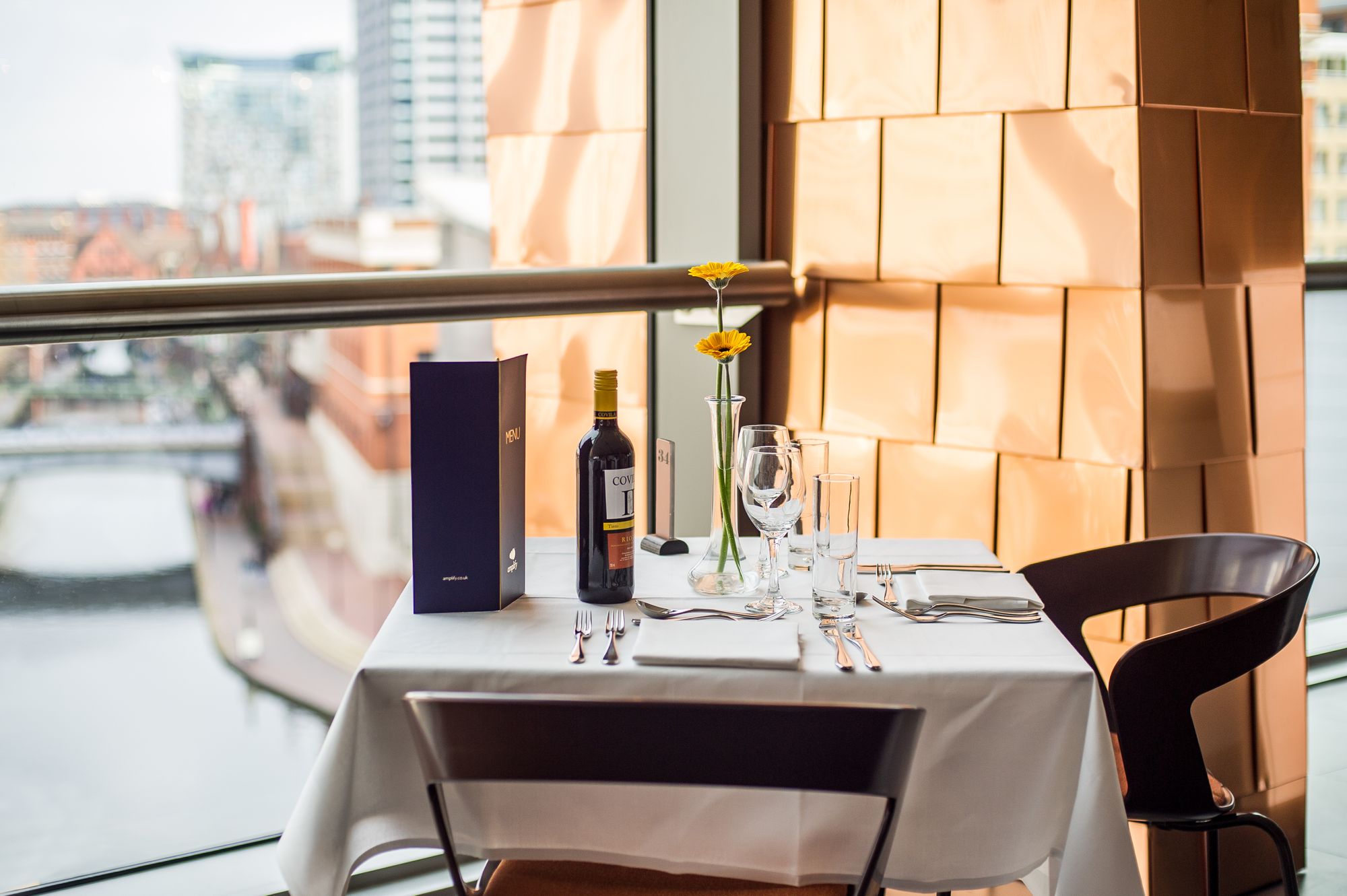 Corner table set with cutlery and wine 